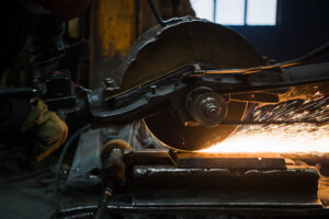 sparks from circular saw at steel factory. metal sawing close up.